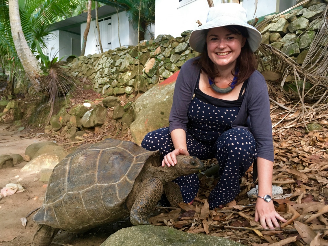 Shannon with a giant tortoise in the Seychelles